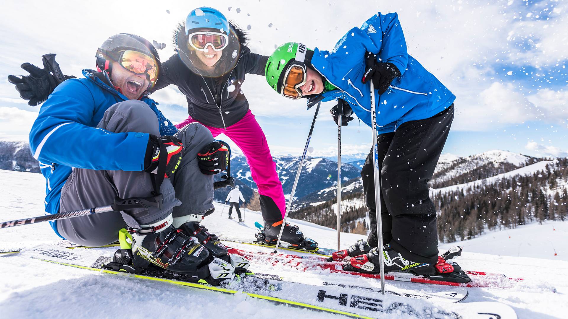 A family of three enjoys the fun on the slopes.
