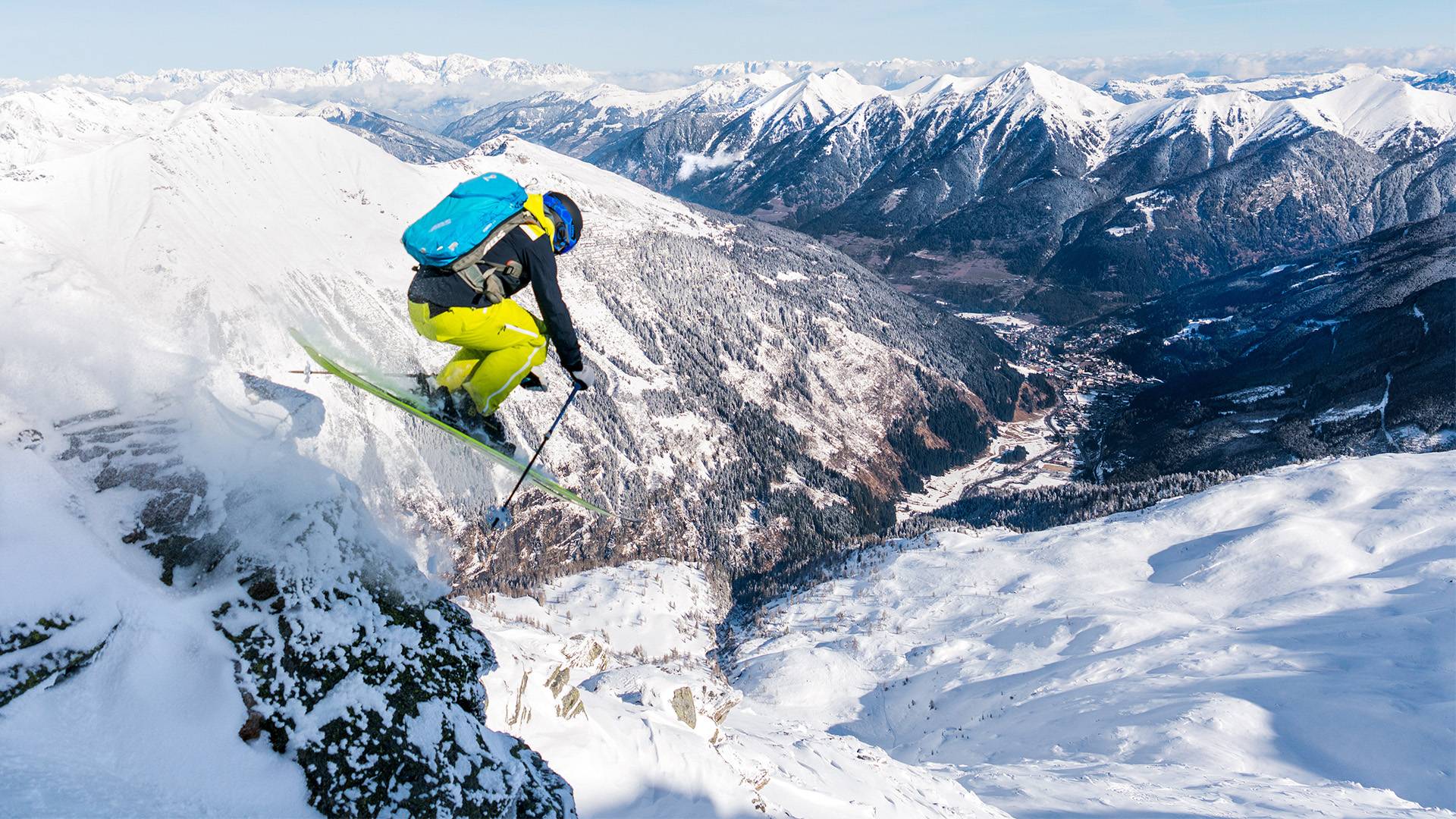 A freestyle skier dares to jump off a steep slope above the Gastein Valley.