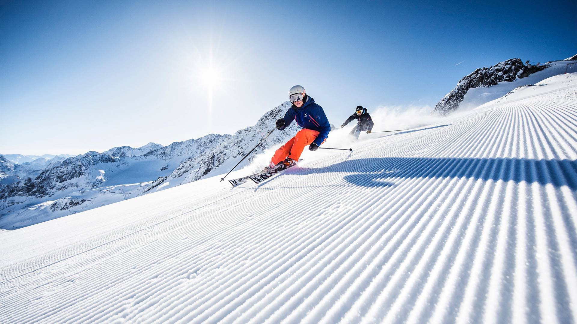 A skier skiing on a freshly groomed slope.