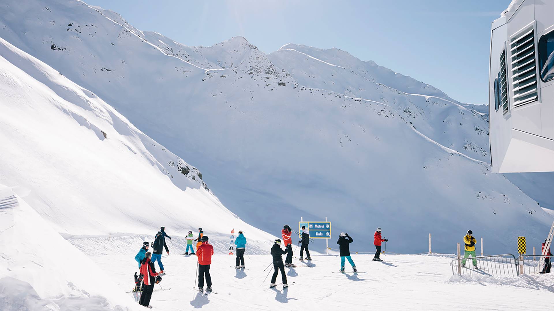 Several people are standing in front of a lift station.