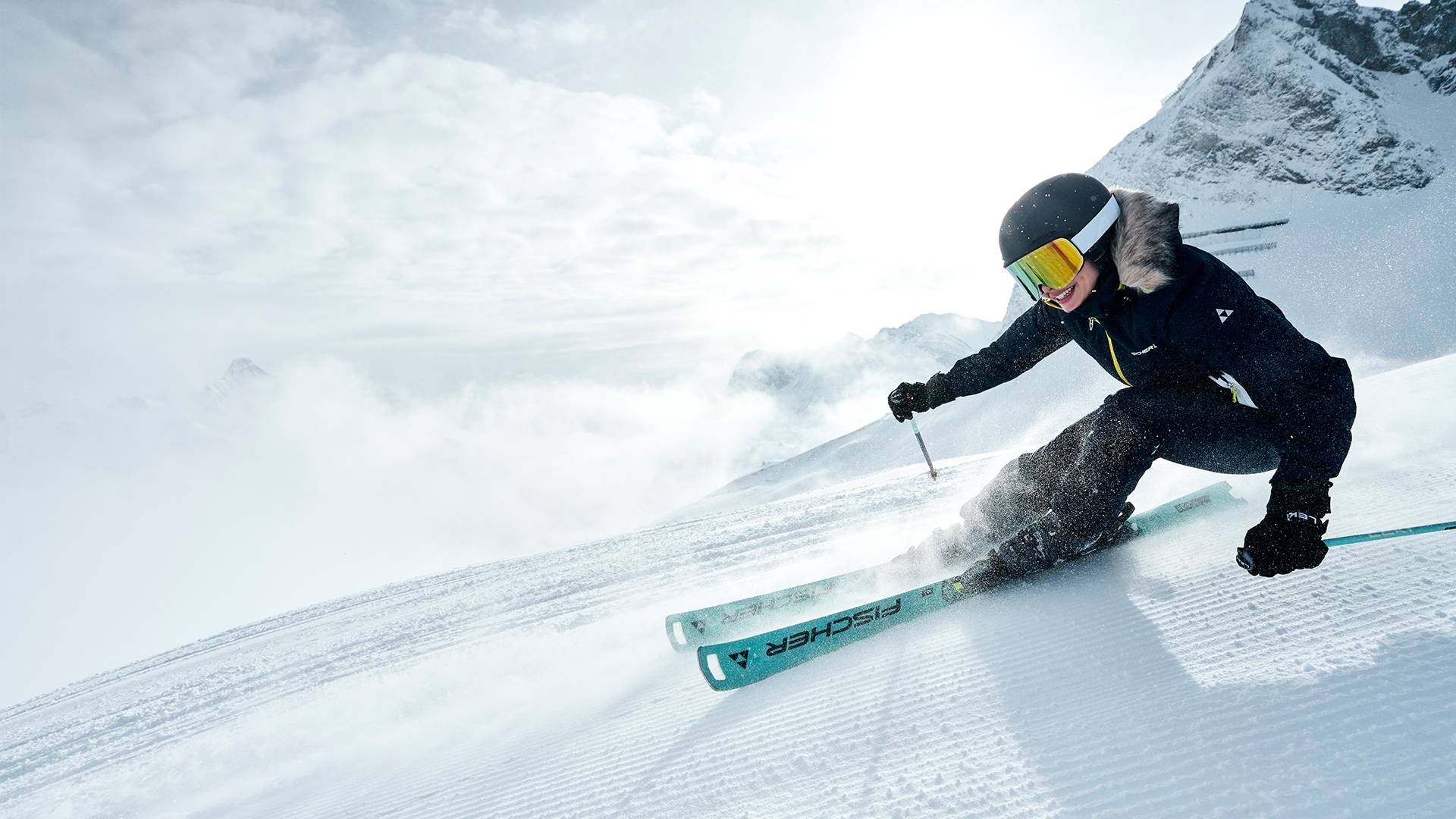 A skier is skiing down a freshly groomed slope.