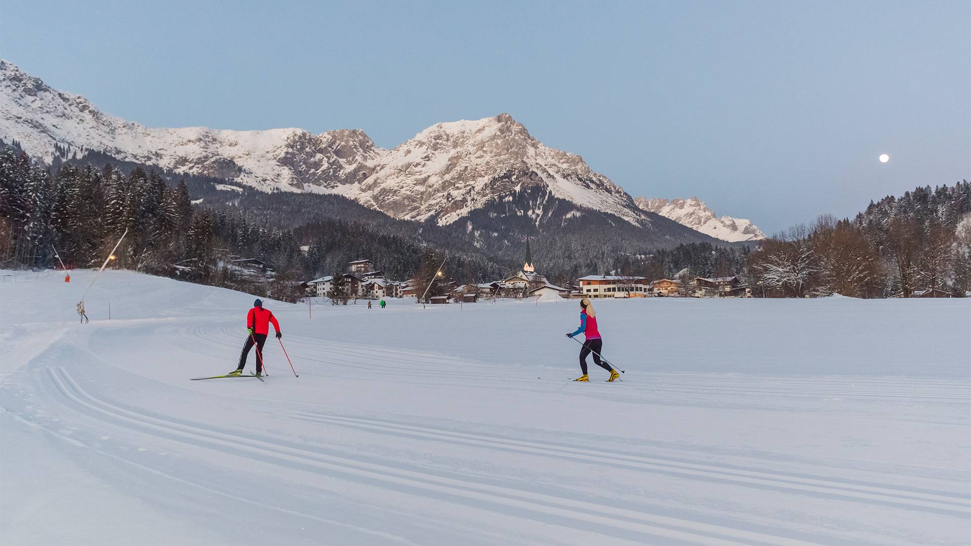 Two cross-country skiers can exert themselves to the full on a perfectly groomed slope.