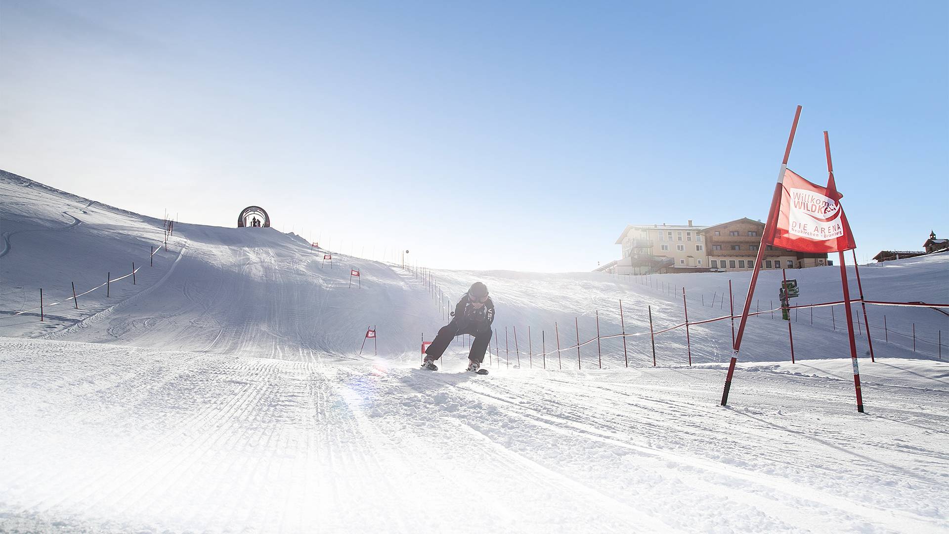 A skier descends a giant slalom run.