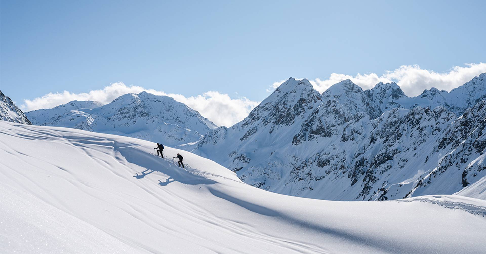 Two ski tourers are climbing the mountain.