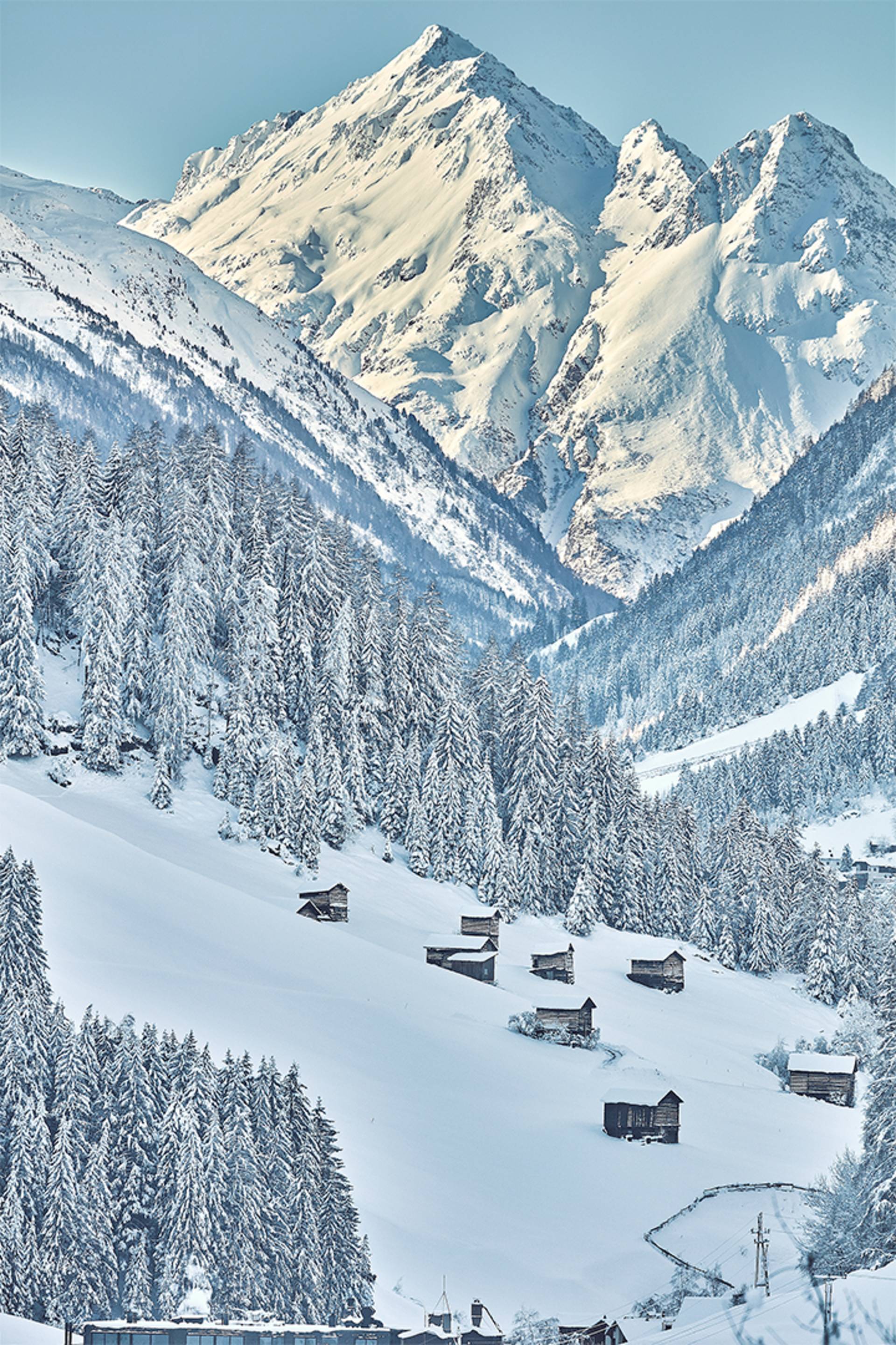 A fantastically beautiful winter landscape can be seen. A snow-covered mountain towers in the background.