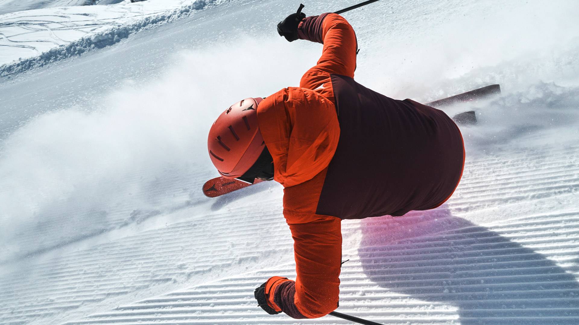 Man met rode jas tijdens het skiën