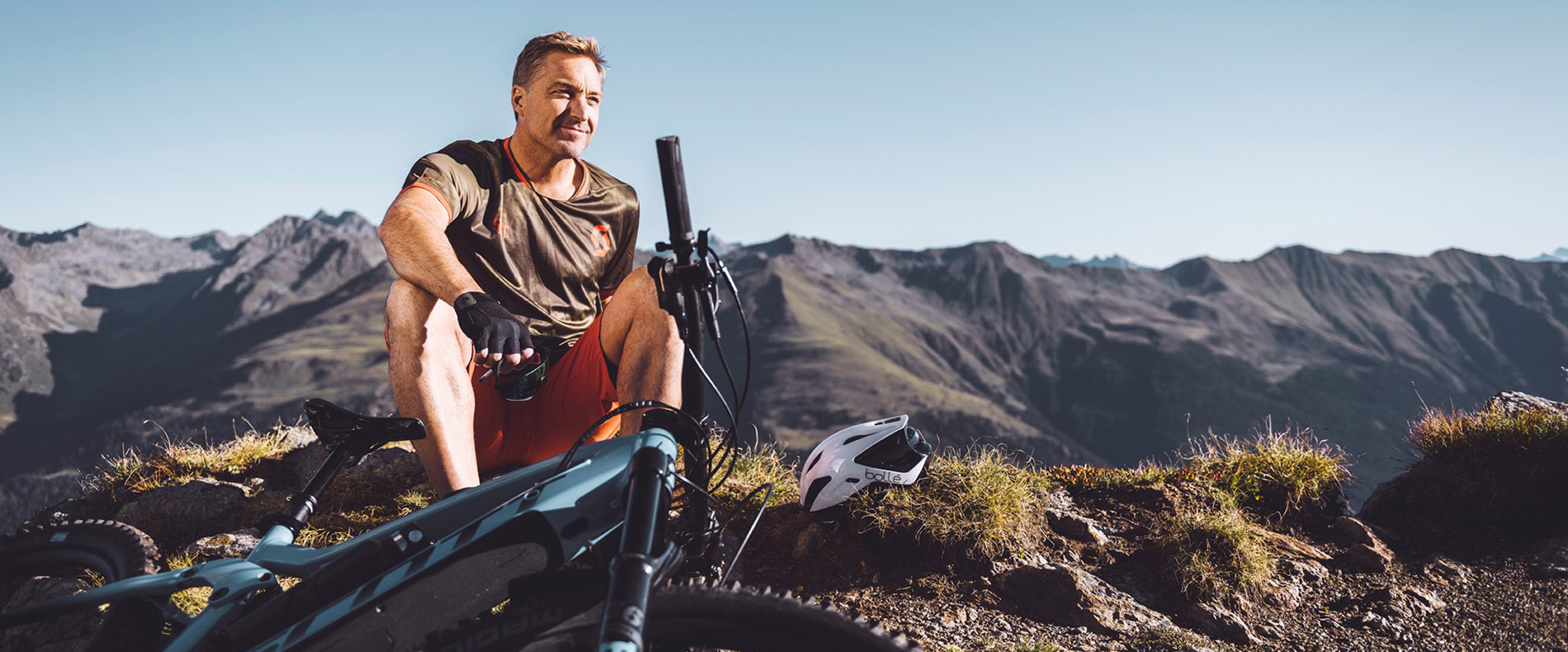 Hans Knauß genießt die Aussicht mit seinem E-Bike am Berg. 